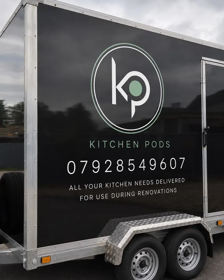 Close-up of the Kitchen Pods branding on the trailer: the KP roundel, KITCHEN PODS wordmark and phone number
